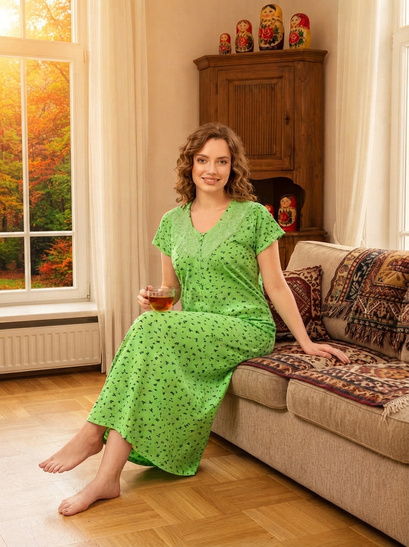 An Indian woman wearing a comfortable printed cotton nighty while drinking coffee on a balcony in a candid morning setting.